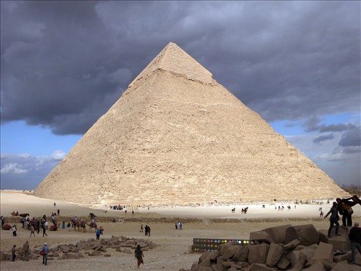 The Pyramid of Khafre shines through the dark clouds above Cairo.