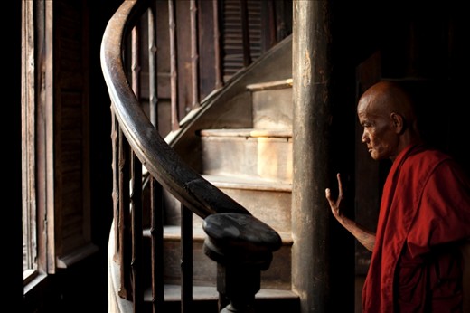 Contemplation: the reticent gatekeeper of the Tingaza Kuang monastery gazes out the window as dusk approaches.
