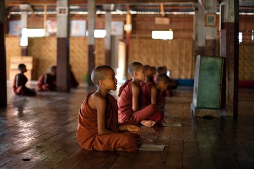 Incantations: young novice monks quietly file into the Htee Tein monastery at dawn to chant prayers in Pali.