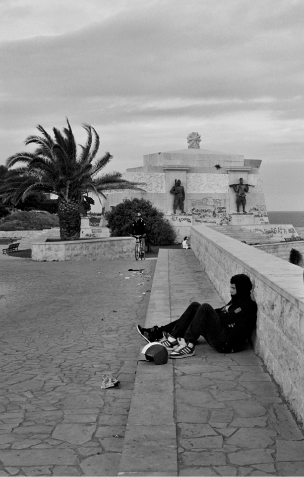 The life:  A waterfront space in Syacusa, Sicily with loitering youth, bicyclists and graffiti (April, 2011, taken with B&W film on my Pentax K1000).