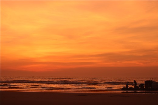 The first fishing boat to return after a long night on the sea at a quiet beach.