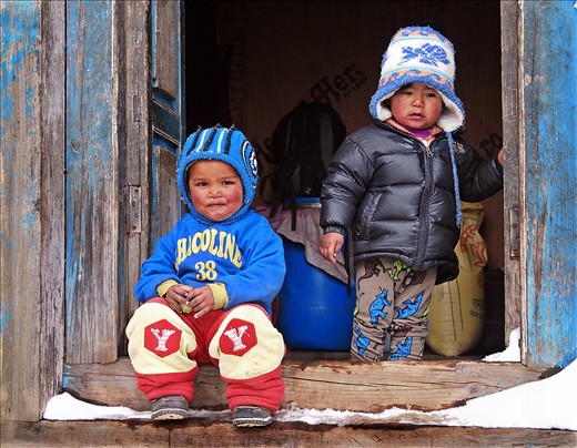 Kids watching the front of their house, while parents are working at the back of the house.