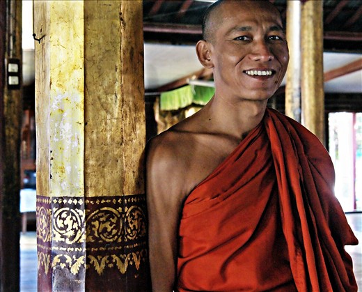 Young novice monk at The Jumping Cat Monestry, this small monastery is built on stilts on Inle Lake, Myanmar (Burma). The monks have taught their cats to jump through hoops. Even cats seem to know how to earn a living.
