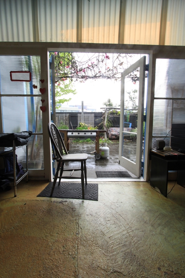 A living room at a hostel in Napier, overlooking its backyard. It was Winter and raining a lot. Most travelers just stayed in the hostel. 