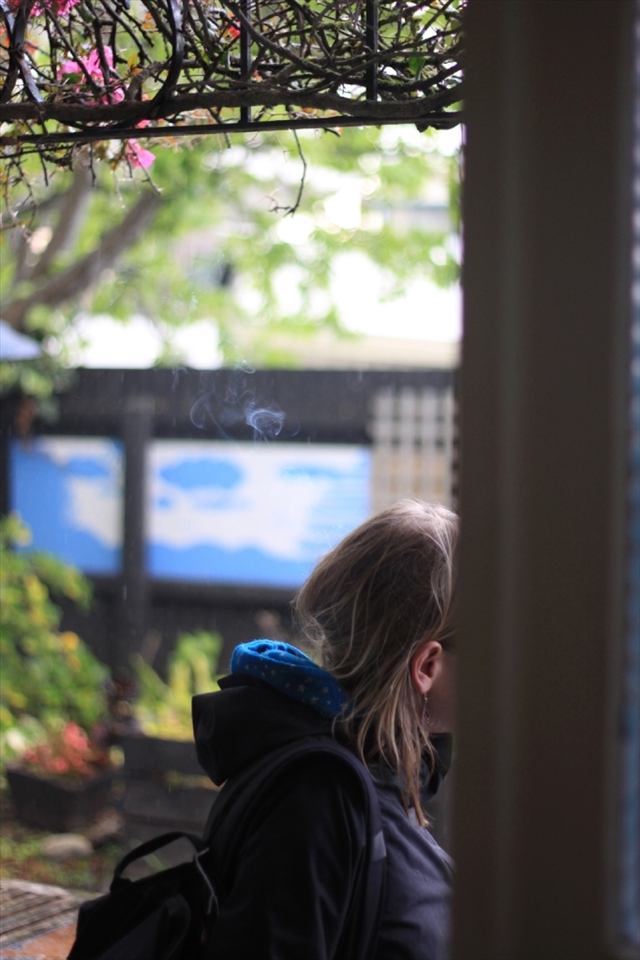 One of the guests smoking at the backyard while waiting for the rain to stop. Napier is  located in Hawke's Bay on the eastern coast of the North Island of New Zealand.