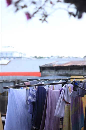 Clothes are left hanging to be dried in the rainy day at the hostel's backyard.  