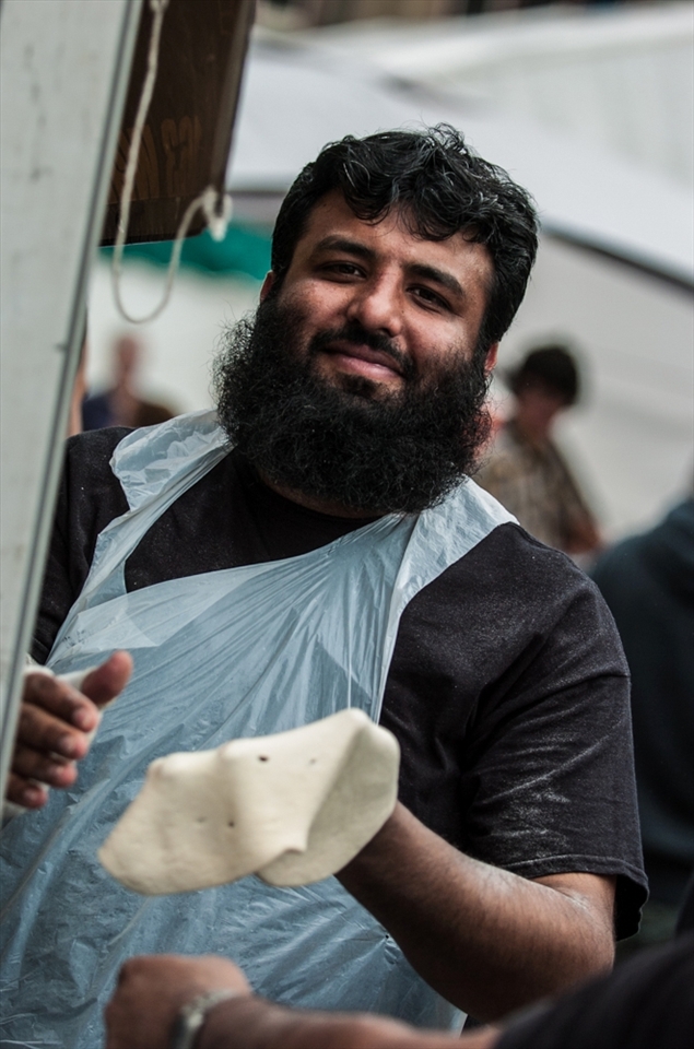 # Kneading

Huddersfield has a hugely diverse population and Food & Drink Festival reflects this.  Here a Pakistani stall holder can't help showing off for the camera as he hand prepares his naan breads.