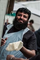 # Kneading

Huddersfield has a hugely diverse population and Food & Drink Festival reflects this.  Here a Pakistani stall holder can't help showing off for the camera as he hand prepares his naan breads.: by edrollasonphoto, Views[398]