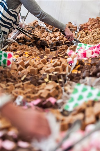 # Feeding Frenzy 

The sweet stall was one of the most popular of the Huddersfield Food & Drink Festival. Here all that can be seen is the eager hands, reaching out to grab a delicacy.