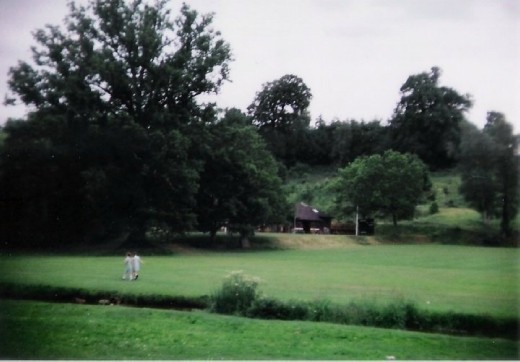 Two little girls holding hands skip across an eerily empty plain.