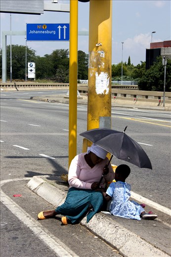 The sun is what ruins her day, the umbrella is what makes it bearable