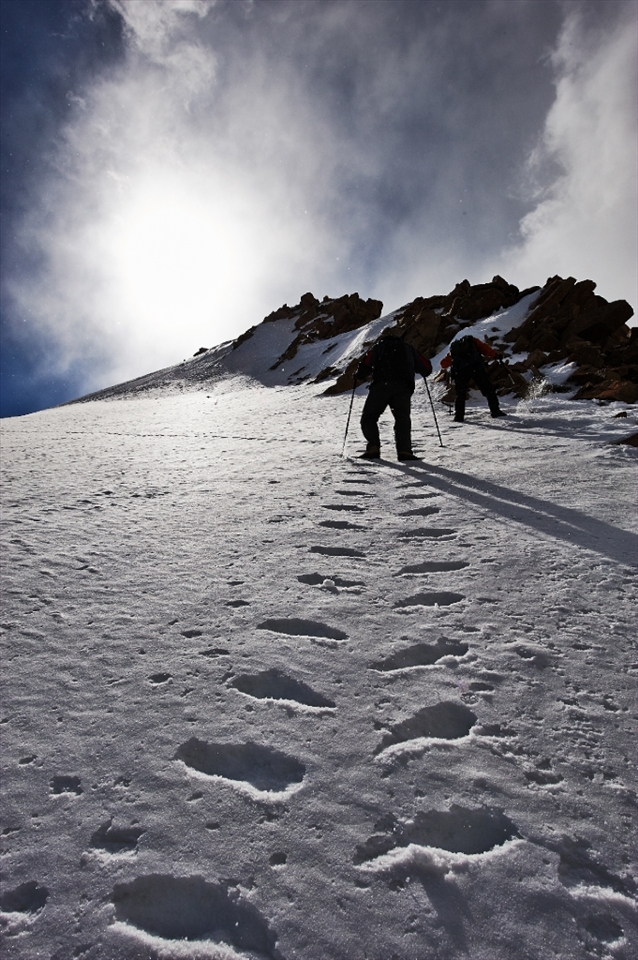 Maxim and Alexander are making their way throw the snow on the glacier of Peak Sovetov. Weather that was nice early in the morning is getting cloudy.