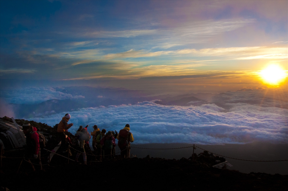 The top of the Mountain has a Temple and Torii gate signaling a successful hike to the climbers.  Reaching the summit by sunrise is a key part of the entire excursion.  It's described as seeing the sun rise over a sea of clouds.  The sunrise from the top of  Mt. Fuji is so powerful it is considered a deity and is called Goraiko.  