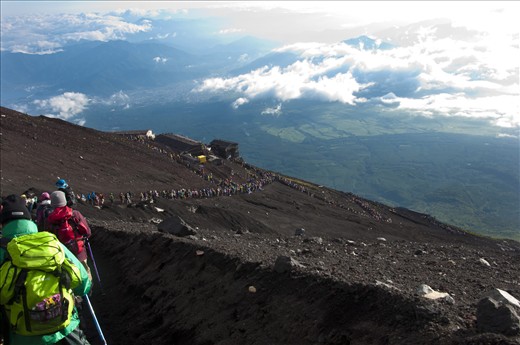 Hikers start their descent at daybreak.  Around 300,000 people come to climb one of japans most famous national symbols every year.