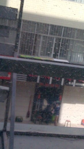 16 October, Baoji, Lunch - a view of a storefront from the restaurant