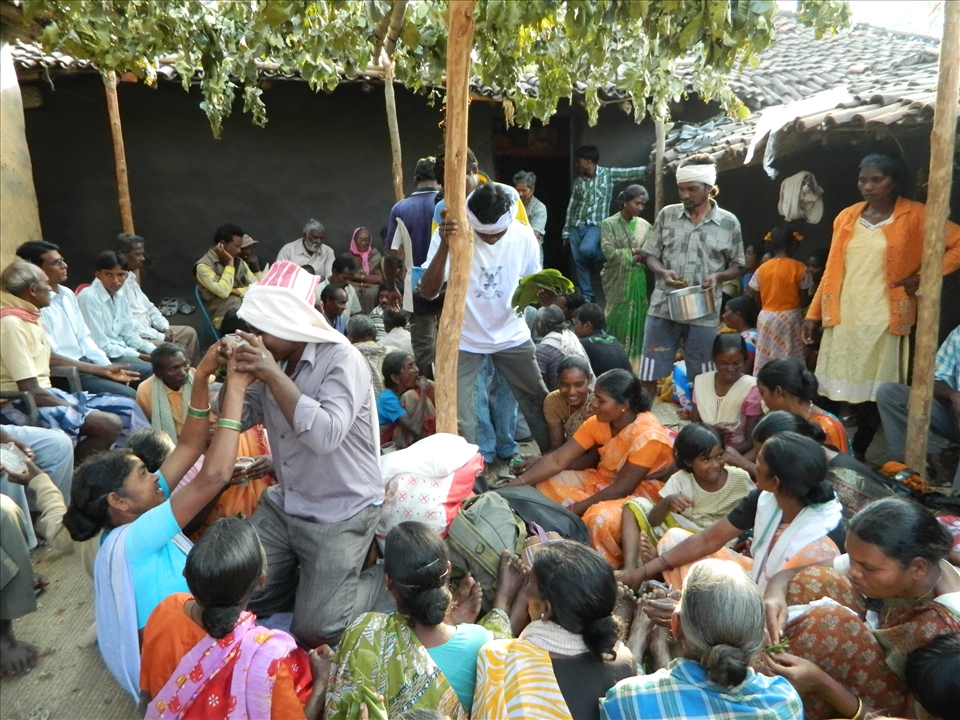 the Boy is offering 'Rice beer' to girl side, some boys are giving some snacks  