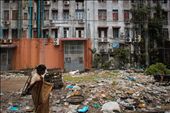 A woman adjusts her longyi as she walks the squalid streets of Yangon.: by emiliehayward, Views[1384]