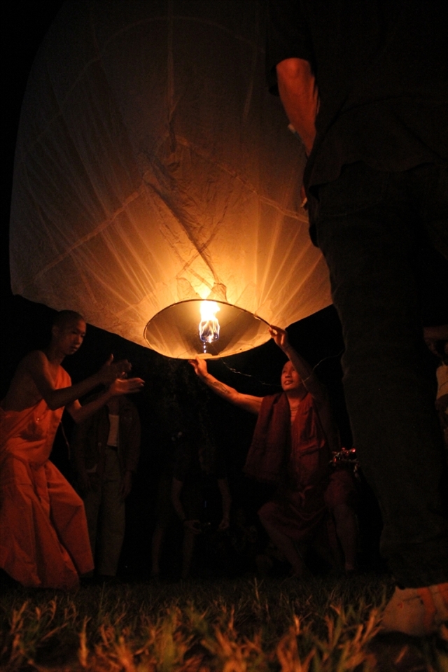 Finally time to let the lantern go, the main monk lets go of the Loi Krathong lantern as the second monk claps along to a chant.