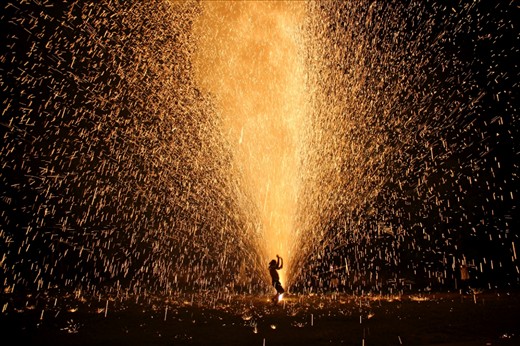 Each year for Loi Krathong, the village makes homemade fireworks and sets them off. This shot captures the joy of the people and the magic of the light. 