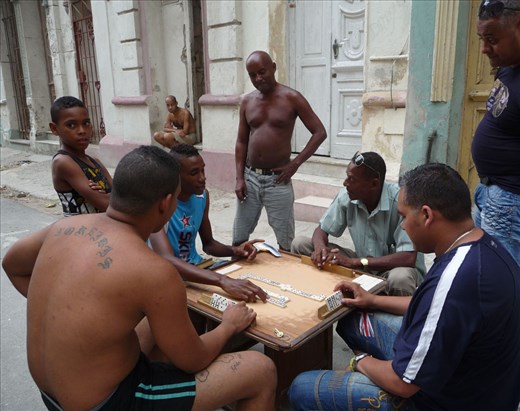 A common sight of passionate men playing dominoes outside their cases.