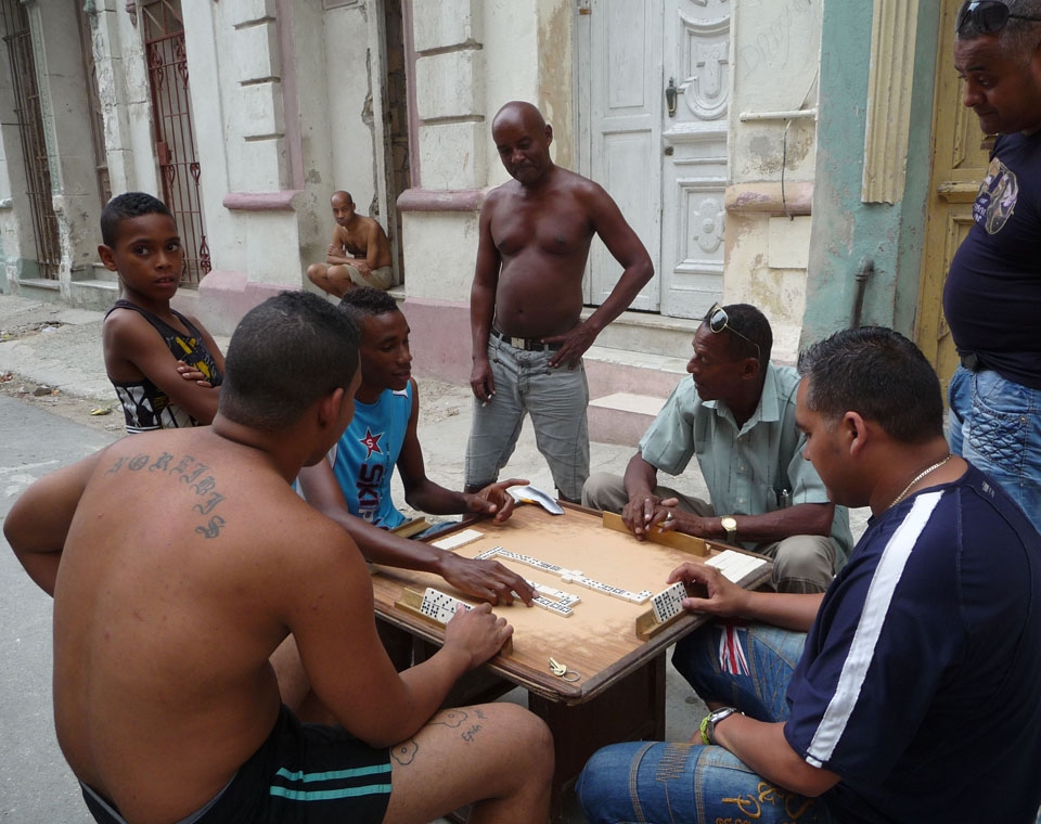A common sight of passionate men playing dominoes outside their cases.