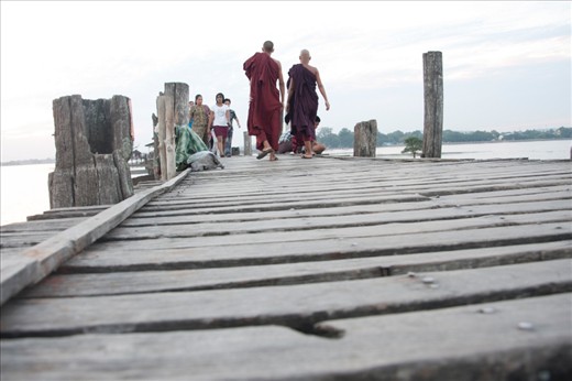 A late afternoon at the U-Bein bridge. Peaceful, nothing looks to have changed in a country stucked into the past for 50 years, except some tourist boats in the distance. 

It's hard to imagine that in 2007 Mandalay, with the most important monastic population of Burma, suffered mass arrests in monasteries during the Saffron Revolution.

Since western medias in early 2012 have promoted the opening of the country that occurred one year before, it has become destination #1 for travel agencies.
