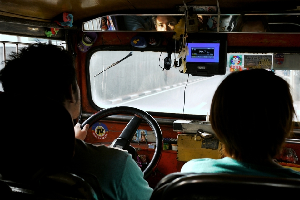 View from the jeepney´s cockpit. Note that the jeepney´s body design is taken from the American military jeep, its engine and parts are taken from discarded Japanese trucks, and its interiors are adorned with religious images ---  influences from nations that occupied the Philippines in the past. (Spain, US, and Japan)