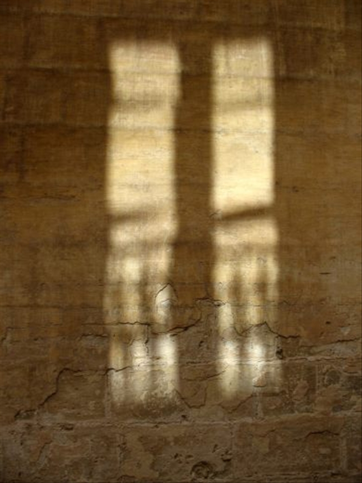 Maltese shadow. A fluctuating window of light.. on thick hard walls