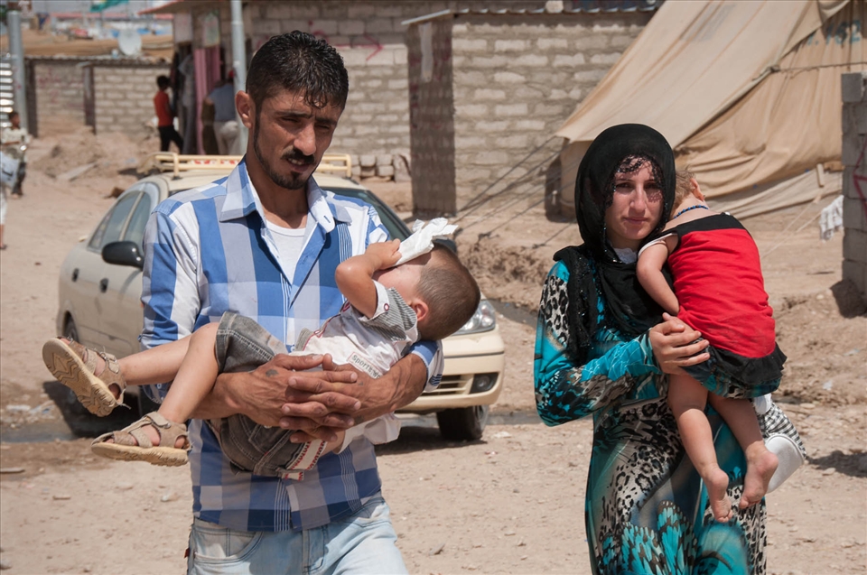 One day of walking divides the Syrian-Iraqi border to the Domiz refugees' camp. Syrian people arriving here after having been travelling for days have nothing to carry but exhausted children and lots of hope in their eyes. Here is a family of refugees just arrived at the Domiz camp, going to finally find a shelter.