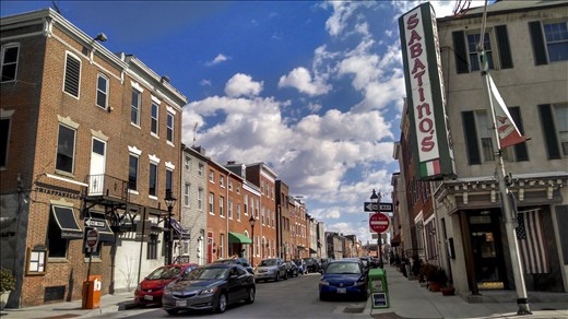 A street of brick houses, deserted in the early hours of a Sunday morning. 