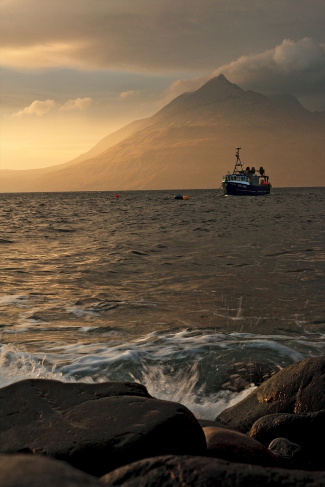 This photograph shows another angle on the Cuillin hills this time from the south at Elgol on the Isle of Skye. Many of these west coast villages are similar and the main industries are fishing and tourism. This trawler is causing controversy amongst local fishermen and marine biologists due to the method of fishing involved. Many are concerned about the state of the fisheries and the sea bed.