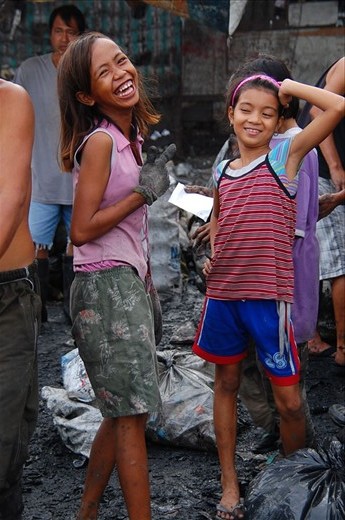 Upon seeing the cameras, these two young ladies stopped what they were doing and gamely posed. It’s not everyday that strangers come to visit them and it must have been a novel experience for them. Despite the extreme poverty they’re in, these people know how to find joy in the little things. 
