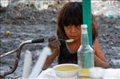 A young boy takes a break from working and takes a moment to eat soup. He seemed famished after working for so long that he finished his soup immediately. For most of us, the idea of eating in the middle of a giant mountain of trash might be unthinkable, but he didn’t seem to mind. 
: by ephesians210, Views[753]