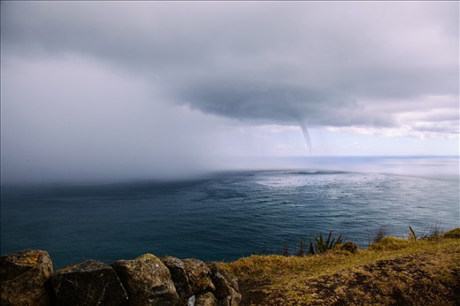 The swirling water intensifies and a funnel begins to form. It's still a 20 minute walk back to the bus, but we can't tear ourselves away from this weather phenomenon.