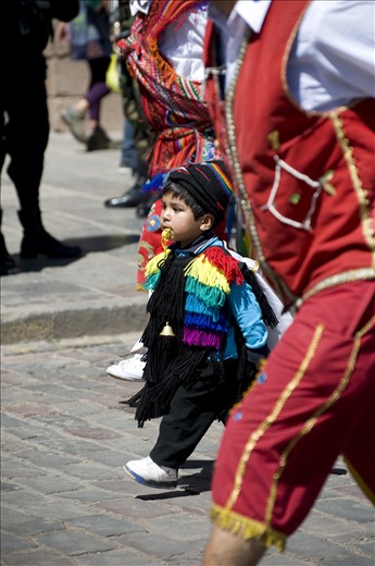A young boy takes part in a celebratory parade for Cuzco's flag. 