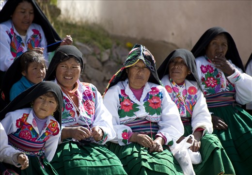 Women of Island  Amantani knitting clothing on a gorgeous day. 