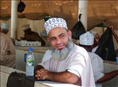 Early in the morning a local is waiting at the famous fishmarket in Muscat, while the fish he just bought is getting disembowelled. He is wearing a kumma, the traditional headgear in Oman.: by evamast, Views[980]