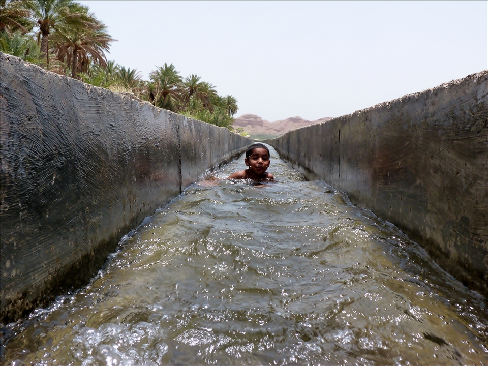 The oldest son of the family enjoys playing around in the aflaaj, the water system of Oman - The waters of life.
