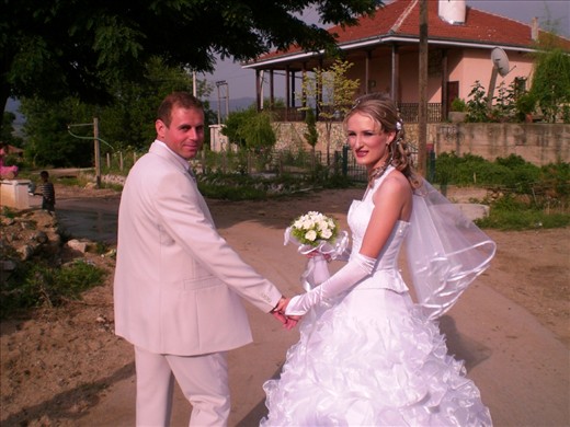 The bride and groom make their way past an old mosque on their way to the village registry office. Weddings in Konce are becoming increasingly modern and westernised - even if certain elements appear to be incongrous at times