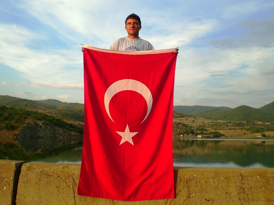 Bekir proudly holds up a Turkish flag. Although many villagers have never travelled out of Macedonia and their culture is a unique combination of South Eastern European and Ottoman, they still identify themselves as being Turkish.