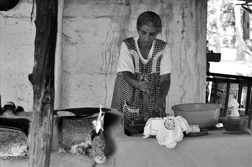 In rural parts deep in the jungle of Bucerias, Maria prepares a home made soft taco for weary adventurers passing by.  The corn is soaked for 3 days before grinding to a dough with a stone mill.  She presses the dough with a home made press and lays the dough on an out door iron plate stove made of stone. She has guacamole, salsa and beans prepped for the tacos.  Delicious.  