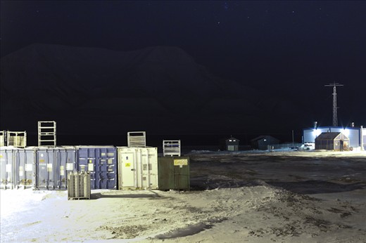 Containers await the arrival of Spring on the frozen fjord.