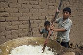Two boys mix sugar cane over heat to prepare a regional specific molasses : by eyeofblitzcraig, Views[290]