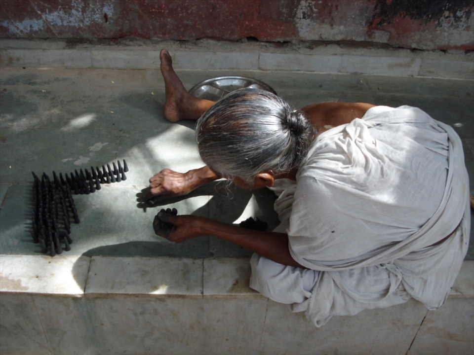 Tapasi, aged 69, spends the entire day rolling incense sticks. After 2 days of hard work she will be payed Rs. 10 (approx. 1/5th of a dollar). She tells us she came here 35 years ago because her family believed that even the shadow of a widow falling on any of them was a curse.