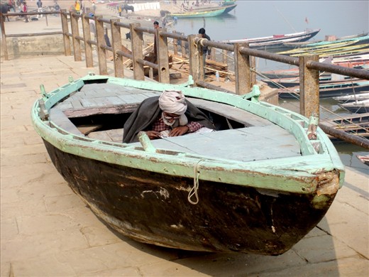 During the day, ghats along the river Ganges are filled with thousands of people, creating chaos that saturates the senses. I liked where this guy found his safe haven... to relax and read the newspapers.  