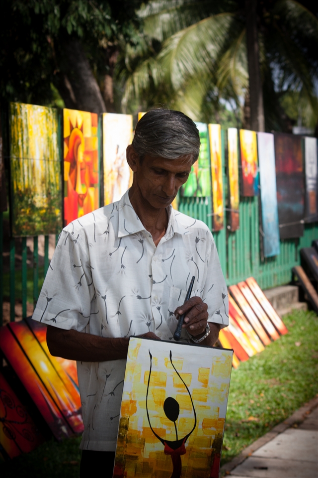 Gunasiri, the painter, was initially reluctant to let me take his picture, for fear the designs would be copied. Gunasiri, as well as several other artists, display their work along Green Path in Colombo. On some days he goes home with close to Rs. 10,000 (US$80) and on other days with nothing.