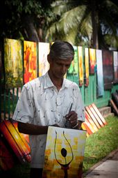 Gunasiri, the painter, was initially reluctant to let me take his picture, for fear the designs would be copied. Gunasiri, as well as several other artists, display their work along Green Path in Colombo. On some days he goes home with close to Rs. 10,000 (US$80) and on other days with nothing.: by fahad_farook, Views[532]