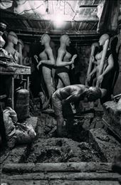 Grapes of Wrath - Kumortuli is an old quarter of Kolkata where families of artists have been working for generations, producing the most beautiful clay deities for the festival of Durga Puja. These deities are born of the Ganges and will be returned to the Ganges. The process begins by gathering clay from the banks of the river, and stomping it into a workable consistency, usually throughout the sweltering summer months.: by fahyje, Views[1338]