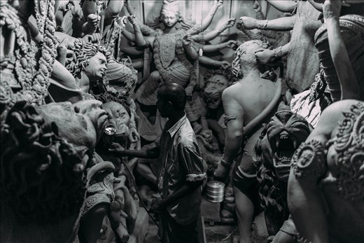 In God's Image - Layers of this clay are added to wooden frames, built to support several deities in standard poses, normally representing popular episodes from the epics. The attention to detail required of these artists means that this is tedious work and though the festival itself lasts only a week, the work goes on throughout the year.