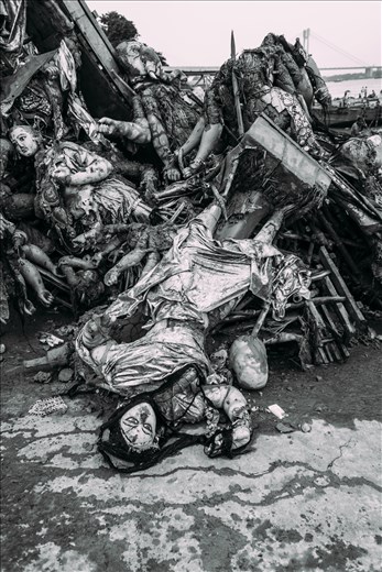 Fate of the Gods - For the sake of efficiency (with constant traffic of life-sized deities arriving at the ghat throughout the day), the deities are fished out of the water feet from where they were dumped. A microcosmic ritual mirroring the Hindu belief in reincarnation, the gods are added to the divine pile of cloth and clay, waiting, as they must, another 51 weeks to be reborn for next year's Durga Puja.